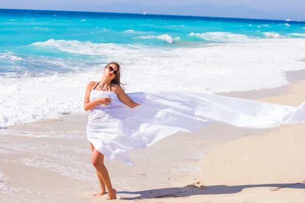 Piękna dziewczyna z białej tkaniny na plaży. — Zdjęcie stockowe
