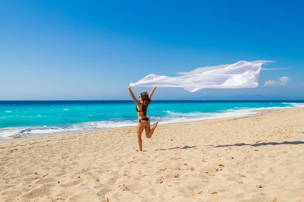 Krásná dívka s bílou tkaninou na pláži. — Stock fotografie