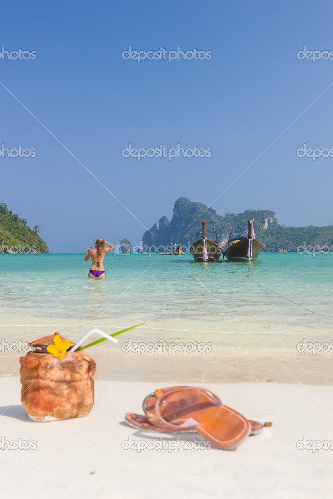 Woman and Coconut drink on the beach in Phi Phi island
