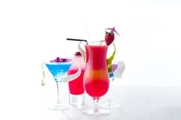 Fresh tropical layered cocktails over white — Stock Photo, Image