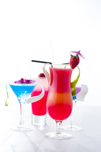 Fresh tropical layered cocktails over white — Stock Photo, Image