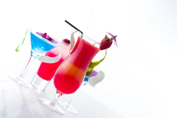 Fresh tropical layered cocktails over white — Stock Photo, Image