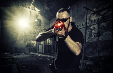 man with a gun and wearing sunglasses clipart