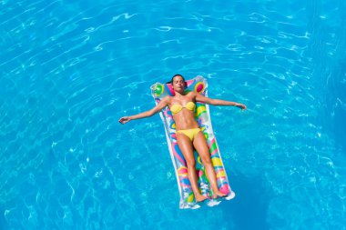 bir kızın rahatlatıcı bir yüzme havuzunda