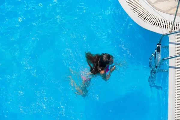 Una ragazza si rilassa in una piscina — Foto Stock