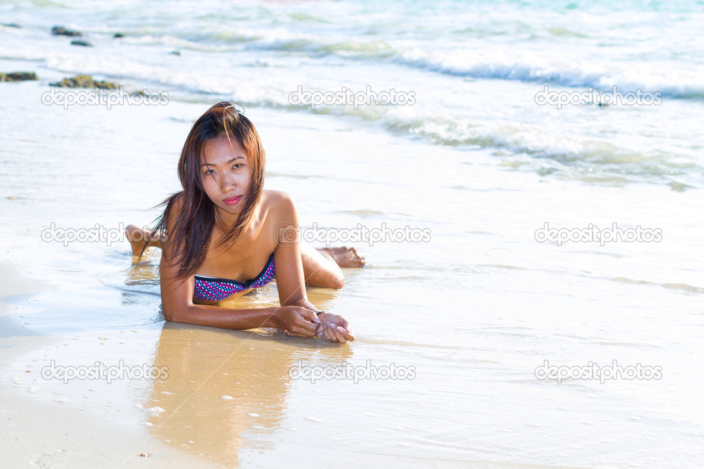 Beautiful Asian model posing on the beach 