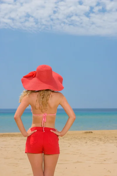 Žena na tropické pláži v červené kalhoty — Stock fotografie