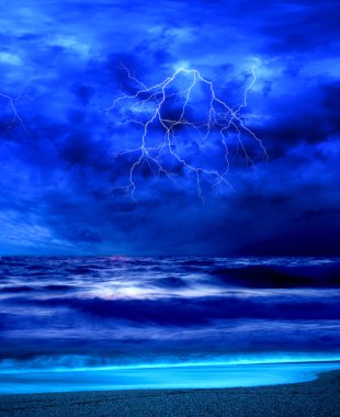 Lightning flashes across the beach from a storm