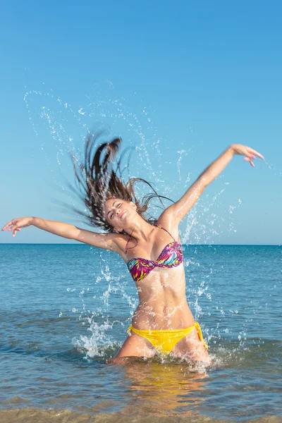 Beauty Model Girl Splashing Water in the ocean Stock Photo