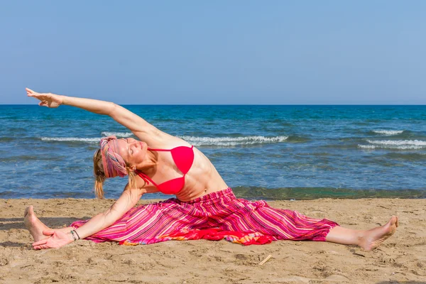 在海滩上练习瑜伽的女人 — 图库照片