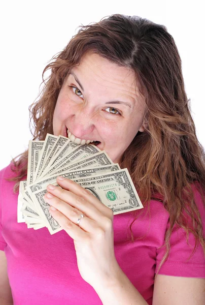 Mujer joven mordiendo dólares por sus dientes — Foto de Stock