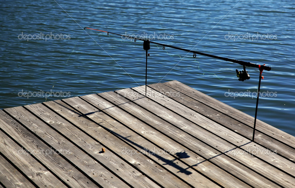 Fishing pole on pier Stock Photo by ©joruba75 13841293