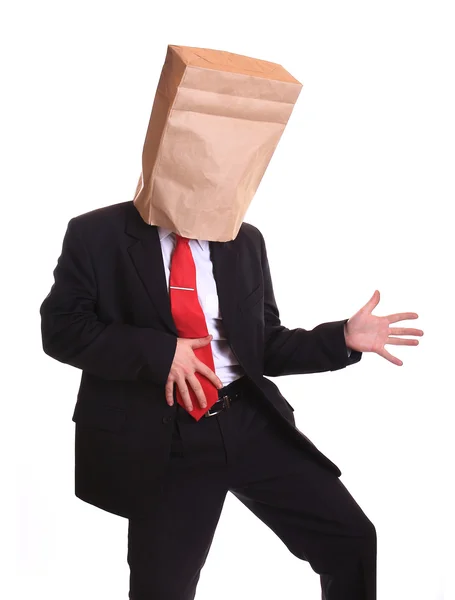 Businessman with a paper bag on head dancing — Stock Photo, Image