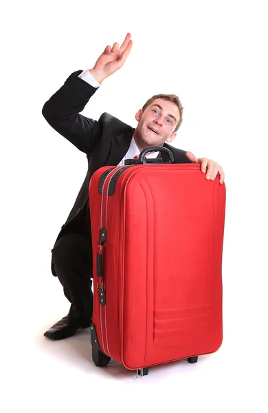 Young man behind red luggage — Stock Photo, Image