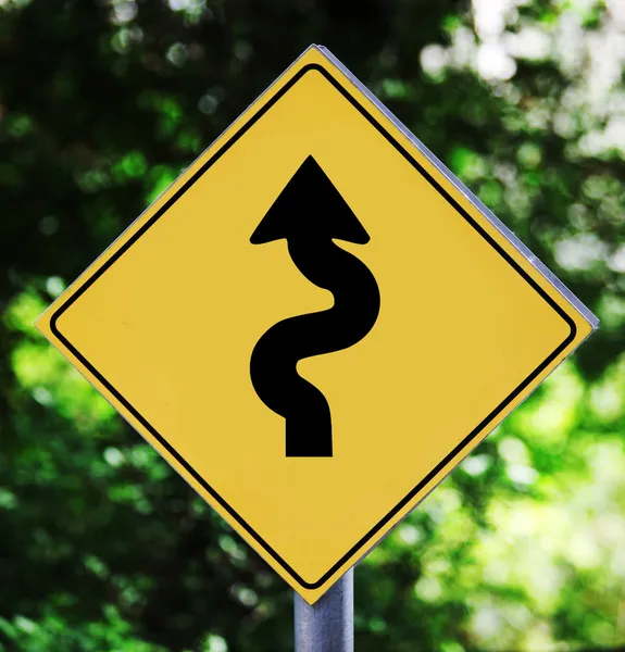 Yellow road sign with bending arrow pictogram — Stock Photo, Image