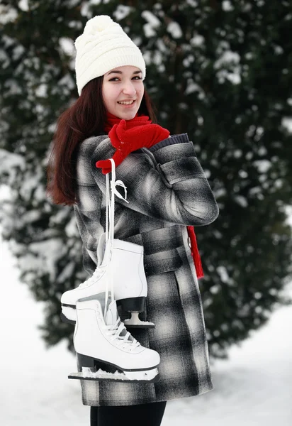 Woman holding ice skates — Stock Photo, Image