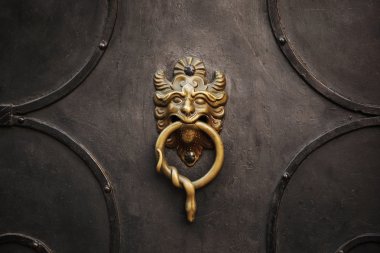 Door knocker with lion on iron door clipart