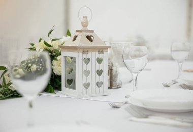 Düğünde çatal bıçak ve tabakla birlikte yuvarlak masa.