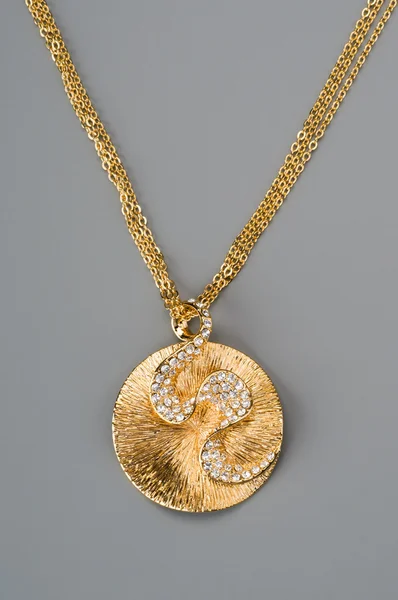 Golden pendant on a chain — Stock Photo, Image