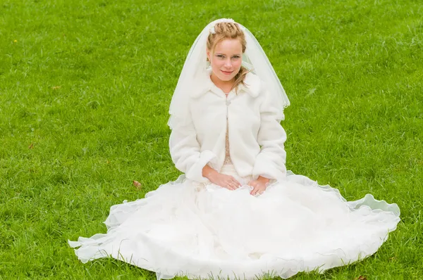 Young bride on a green grass — Stock Photo, Image