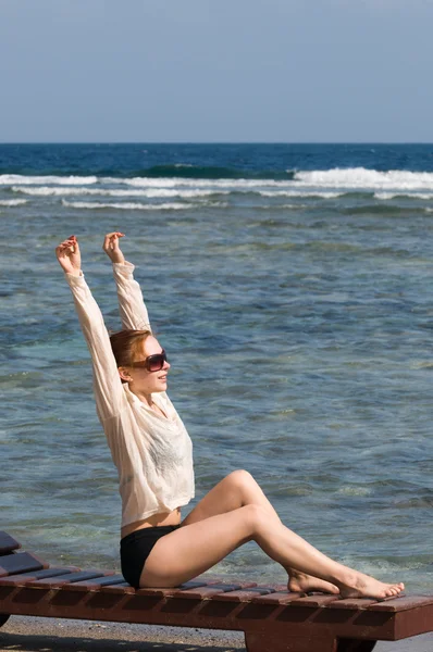 Jovem mulher vermelha tomando banho de sol — Fotografia de Stock