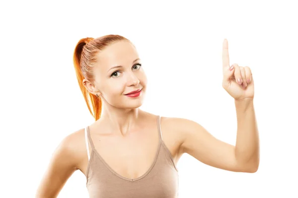 Young woman with healthy skin pointing up — Stok fotoğraf