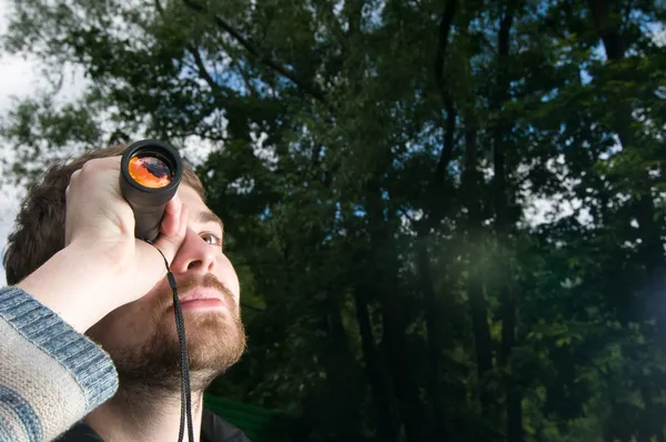 Young man with spyglass — Stock Photo, Image