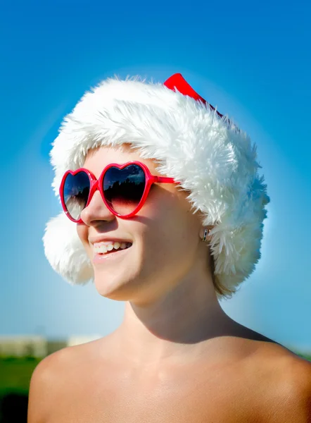 Santa girl wearing heart shaped sunglasses — Stock Photo, Image