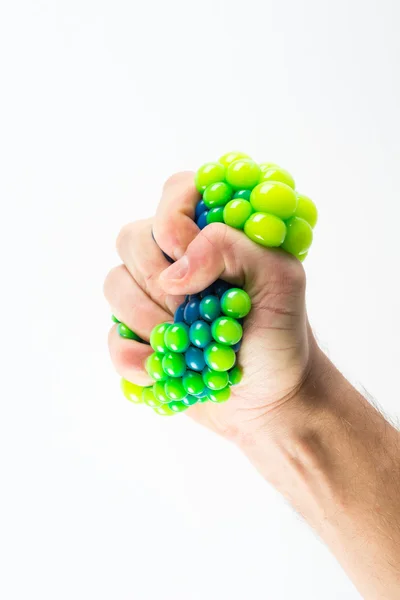 Mão masculina apertando bola de estresse — Fotografia de Stock