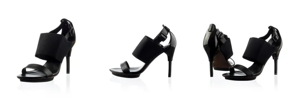 Svarta kvinnliga skor över vita — Stockfoto