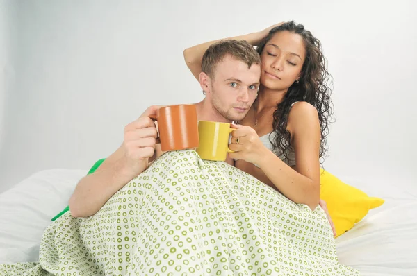 Jeune couple au lit avec café — Photo