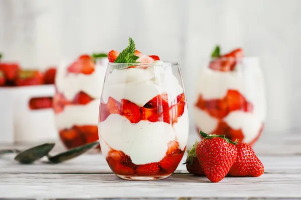 用新鲜的水果和酸奶在乡村的白桌上做的草莓番茄酱做的健康早餐 选择重点放在前面的玻璃瓶上 模糊的背景和前景 — 图库照片