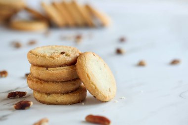 Stack of pecan sandies cookies. Selective focus with blurred foreground and background. clipart