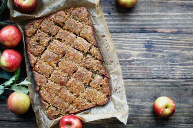 Gluten free almond and walnut cake with sweet syrup topping. Made with almond flour perfect for Passover, Rosh Hashanah or an autumn dessert. Table top view over rustic wood background.