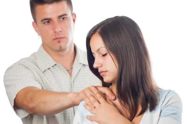 Young man supporting his sad girlfriend isolated on white. Stock Photo