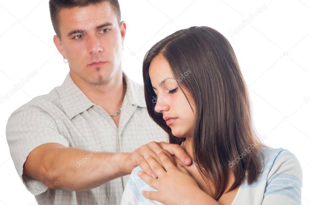 Young man supporting his sad girlfriend isolated on white.