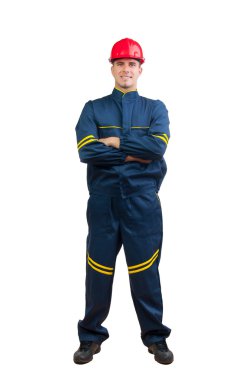 Young happy construction worker in blue uniform and red hard hat isolated on white.