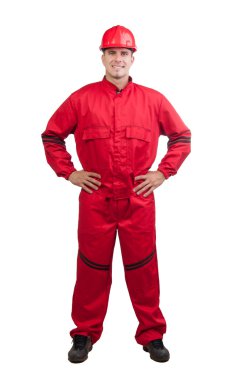 Young smiling fireman or construction worker with hard hat and in full uniform isolated on white.