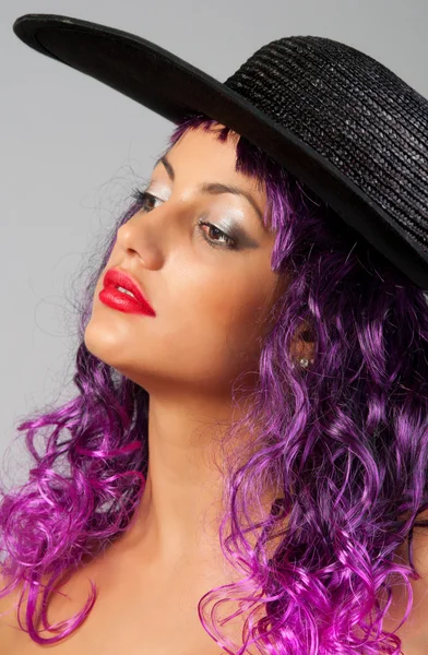 Portrait of beautiful sexy girl with purple hair and black hat — Stock Photo, Image