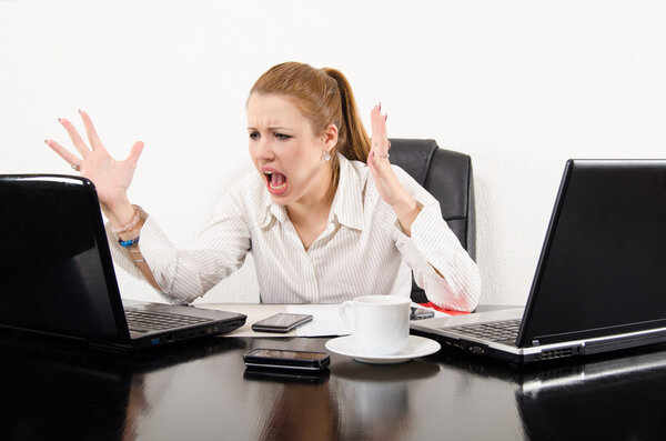 Business woman multitasking and frustrated by modern technology.