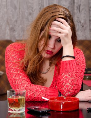 Depressed young woman drinking and smoking clipart