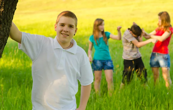 Adolescente menino com seus amigos na natureza — Fotografia de Stock