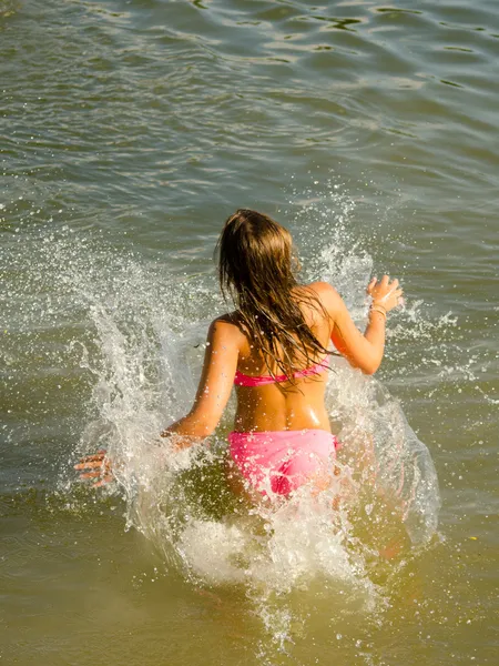 Girl jumping into the river Stock Photo