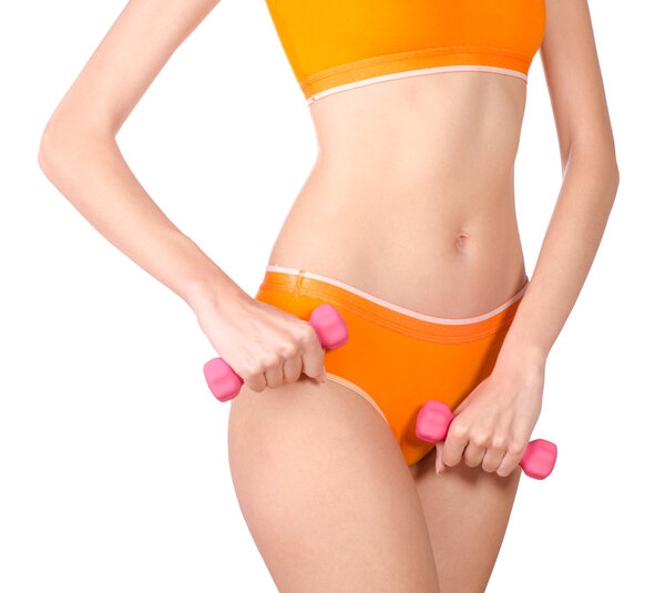 Fit slim woman exercising with dumbbells