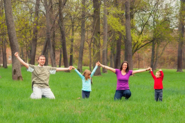 Young family having fun in the forest — Stock Photo, Image