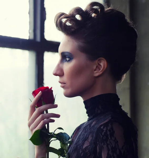 Beautiful elegant woman holding red rose — Stock Photo, Image