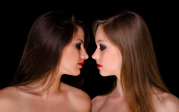 Profiles of two beautiful girls being intimate — Stock Photo, Image