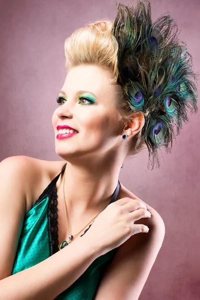 Beautiful woman with peacock feathers — Stock Photo, Image