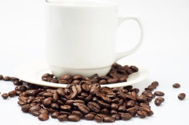 Coffee beans and white coffee mugs