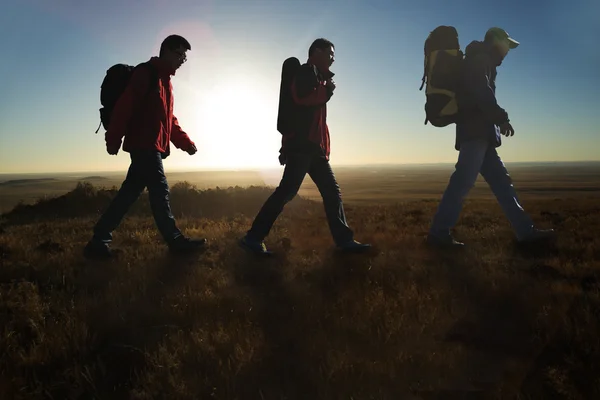 Walking in the sunglow hikers — Stock Photo, Image